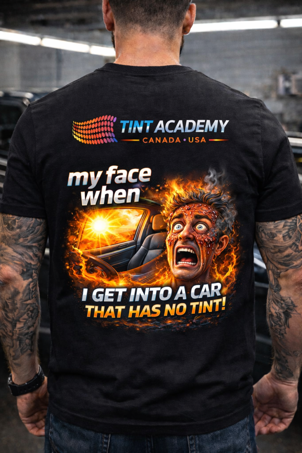 Professional window tint installer wearing Tint Academy apparel with a burn face from tinting work.